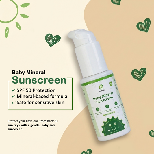 Baby mineral sunscreen bottle with green and white design on a beige background