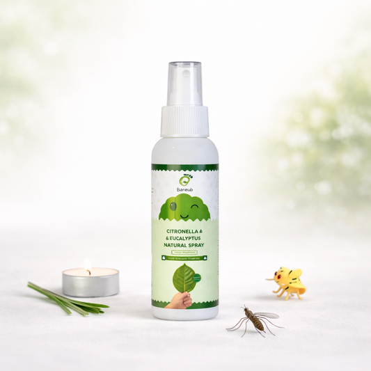 Bottle of citronella and eucalyptus insect repellent spray with a candle, toy frog, and toy mosquito on a white background.