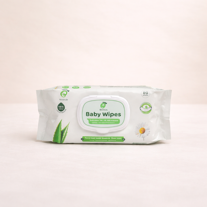 Pack of baby wipes with green accents on a light beige background